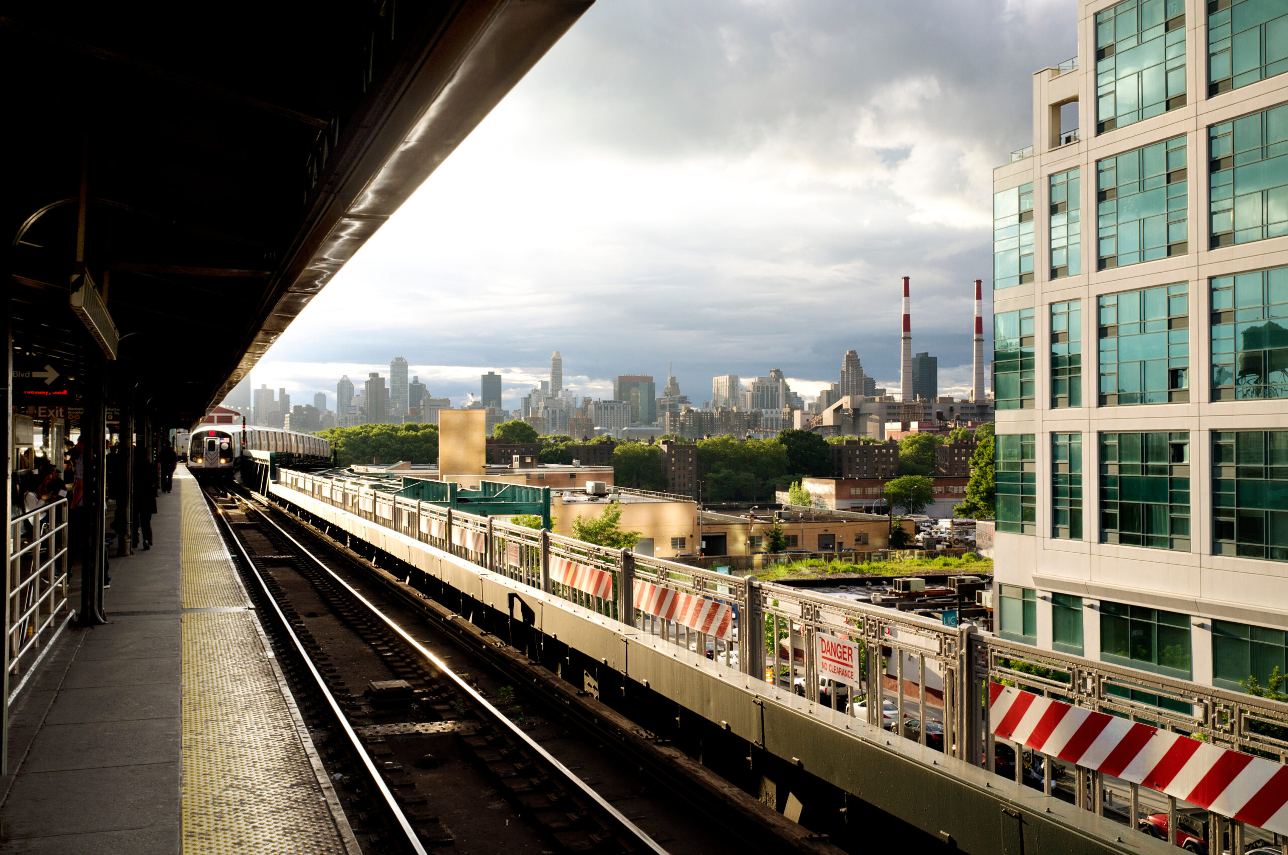 Train arriving at railroad track against building in city