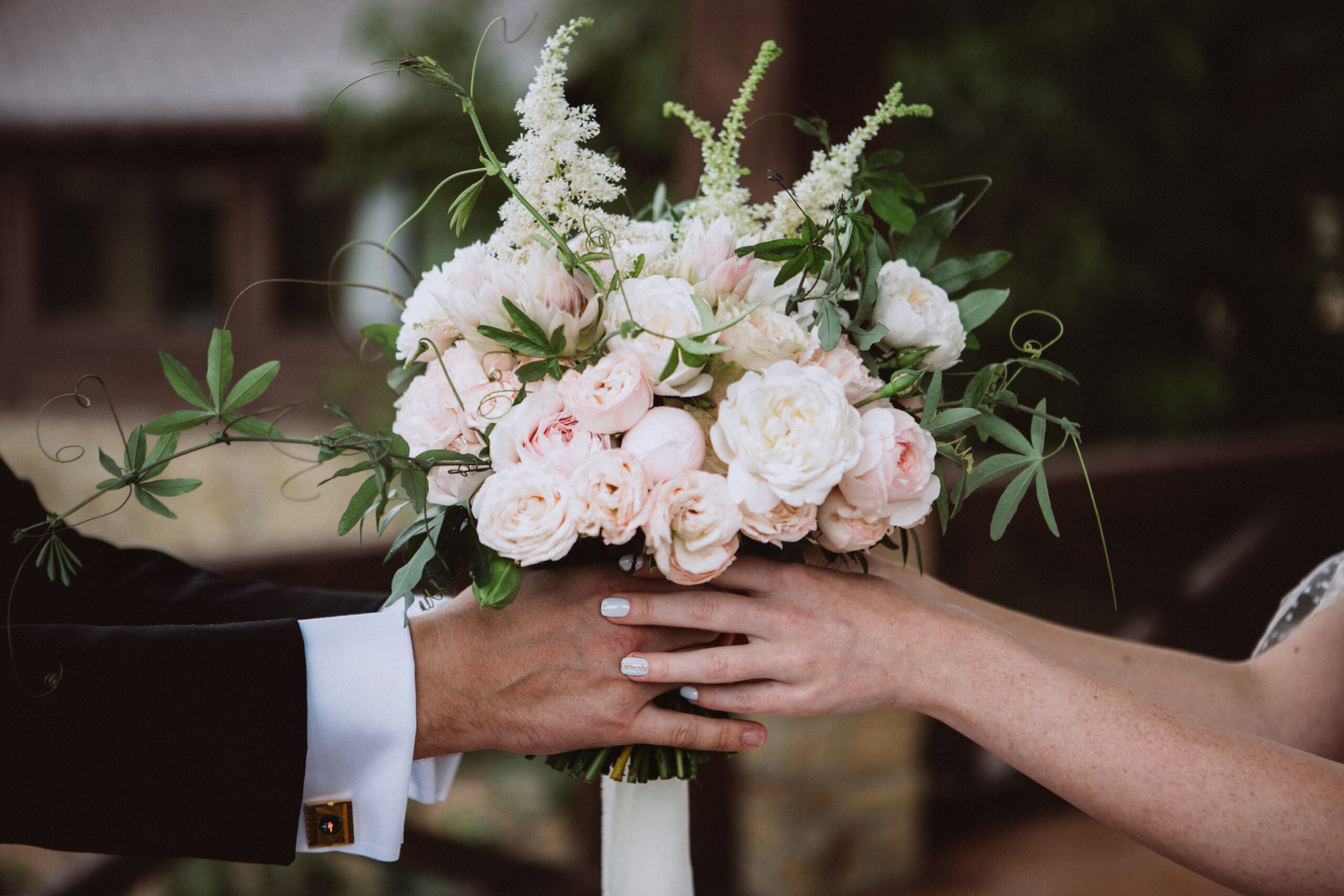 bride and groom holding wedding flowers. Wedding bouquet.